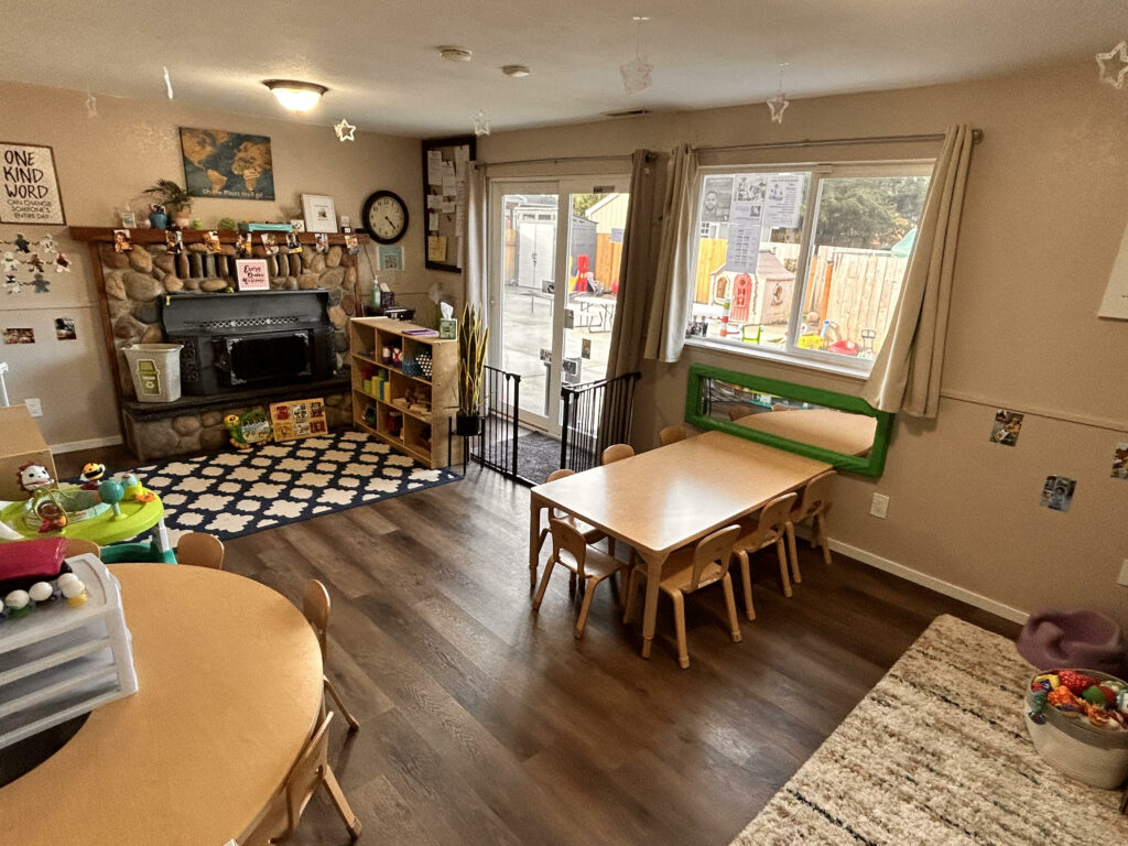 A home child care center with wood floors and tables and natural sunlight